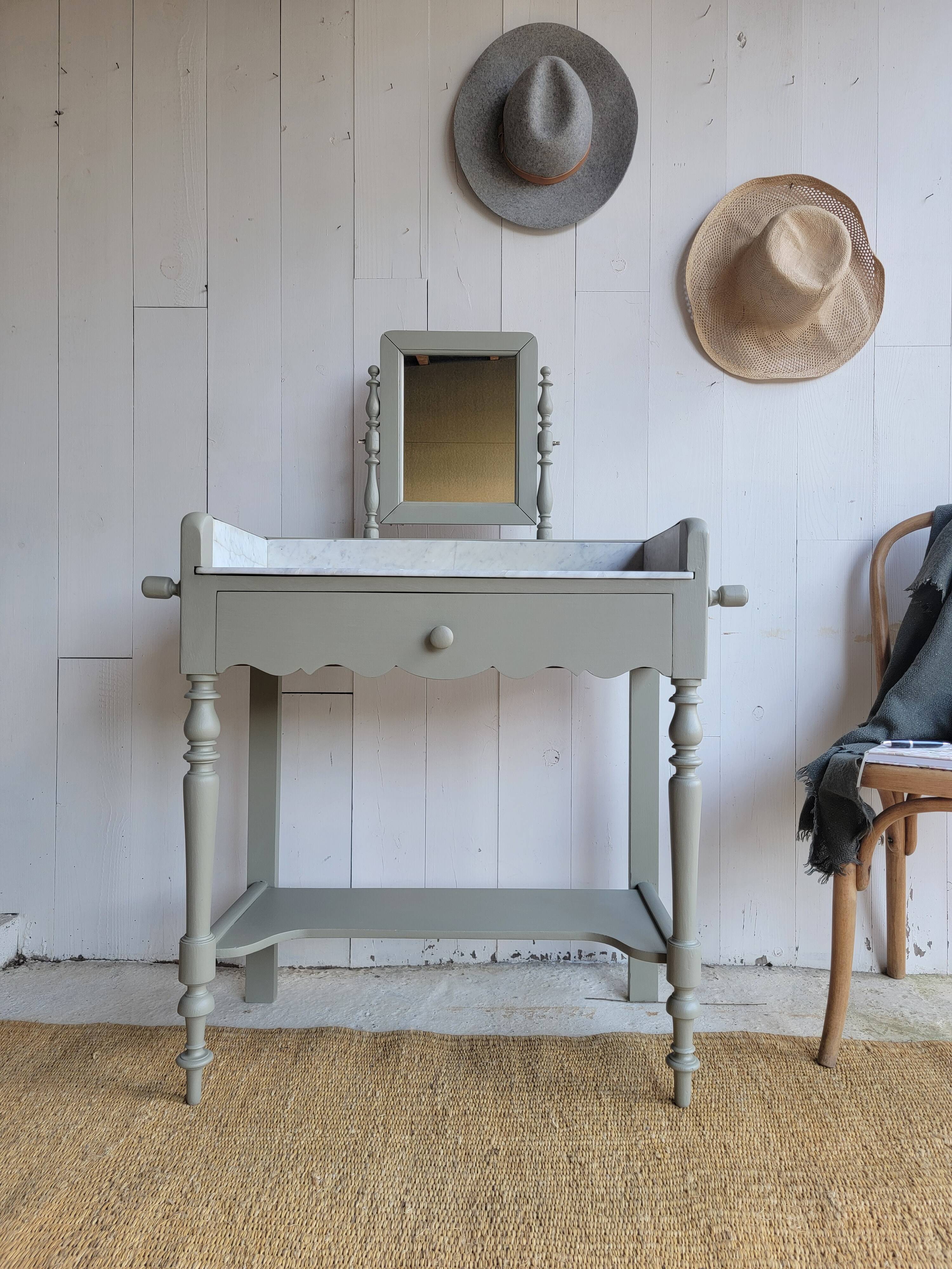 Antique wooden dressing table with marble top and mirror.