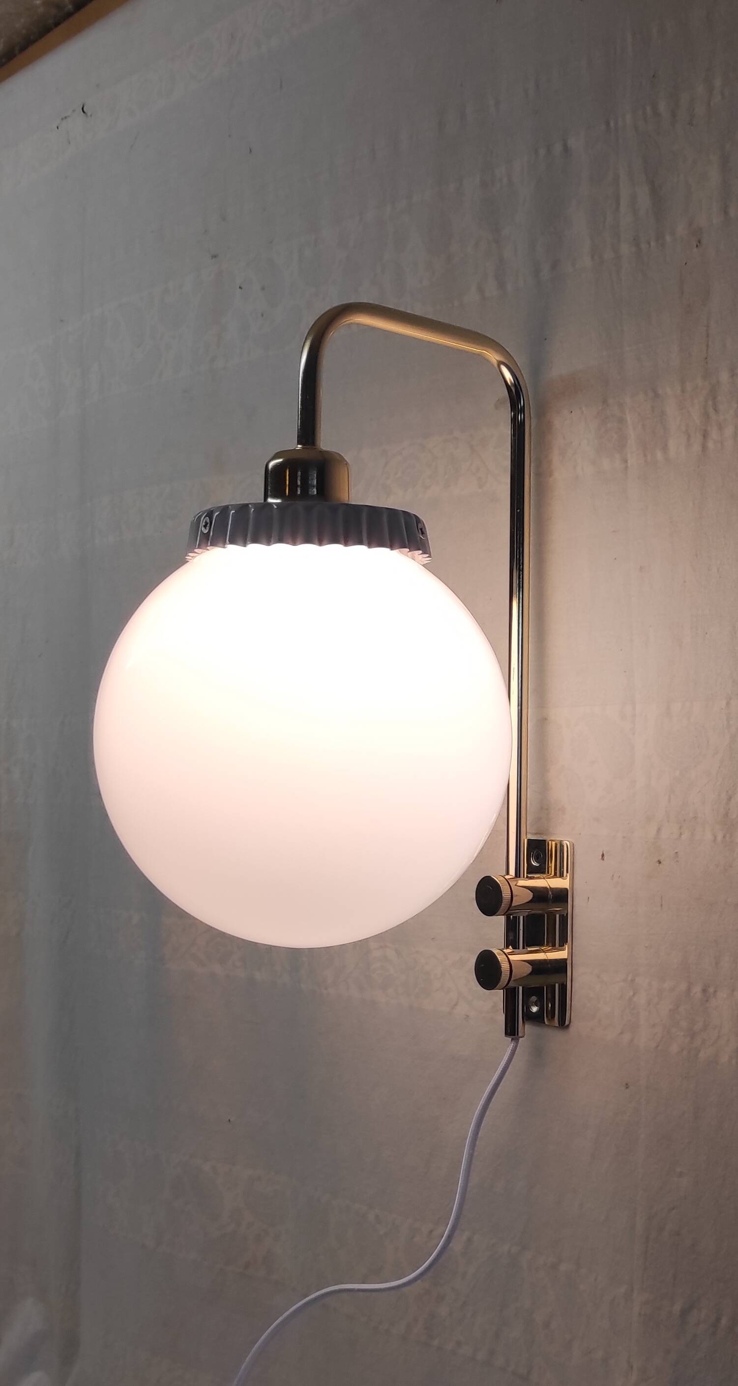 Opaline glass globe wall sconce with a gilt metal bracket - mid-20th century