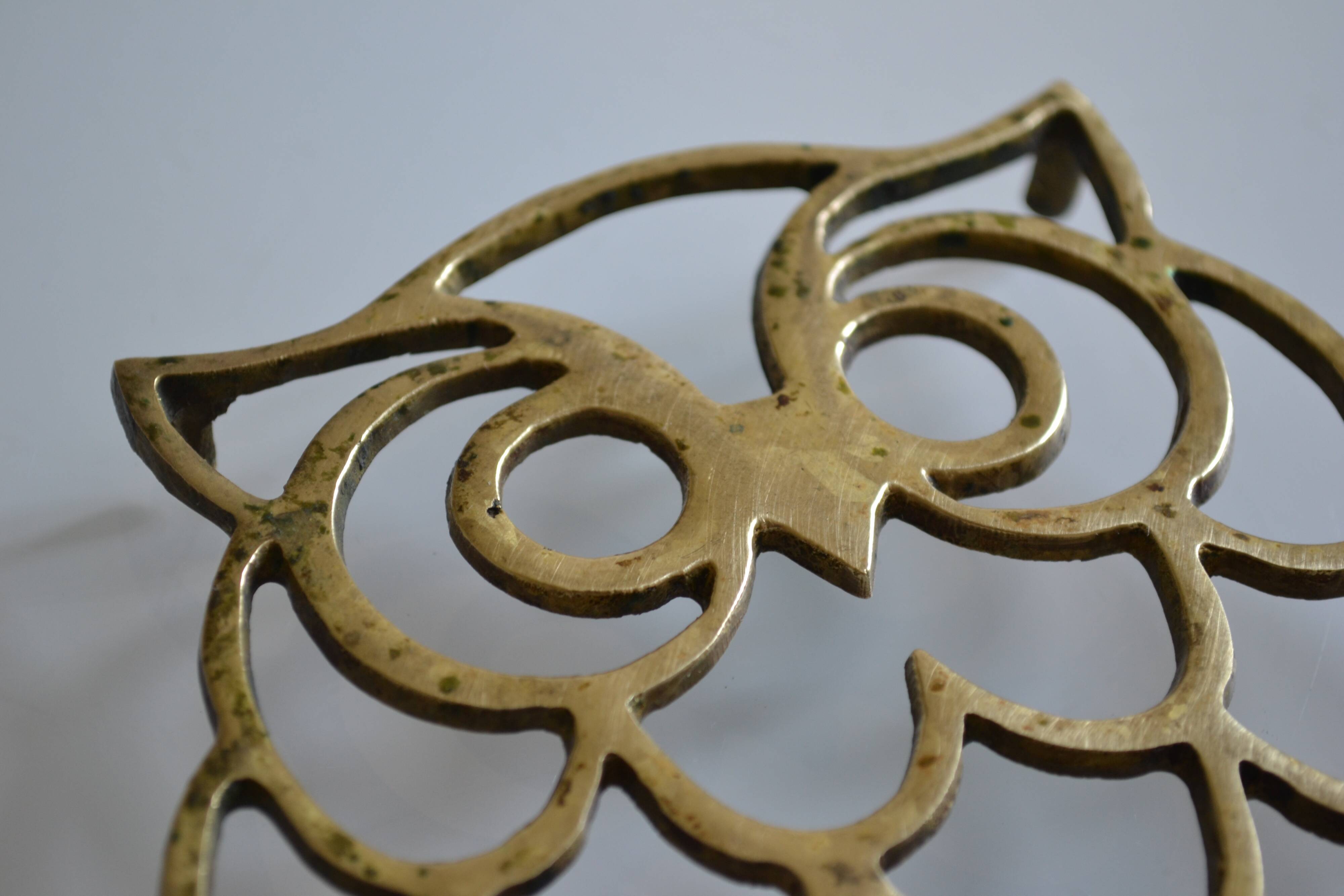 Vintage openwork brass trivet in the shape of an owl or owl