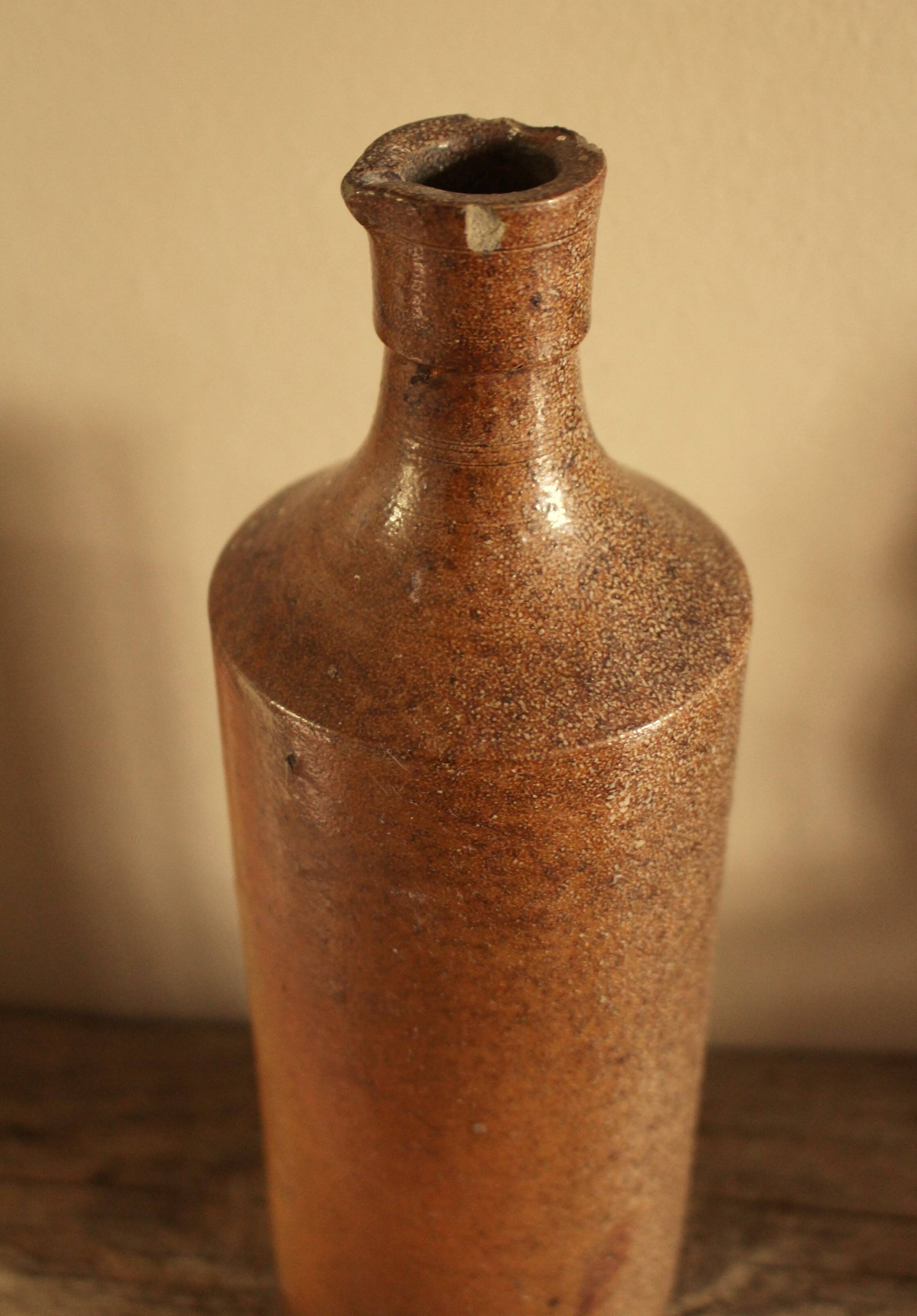Vintage stoneware liqueur bottle with spout