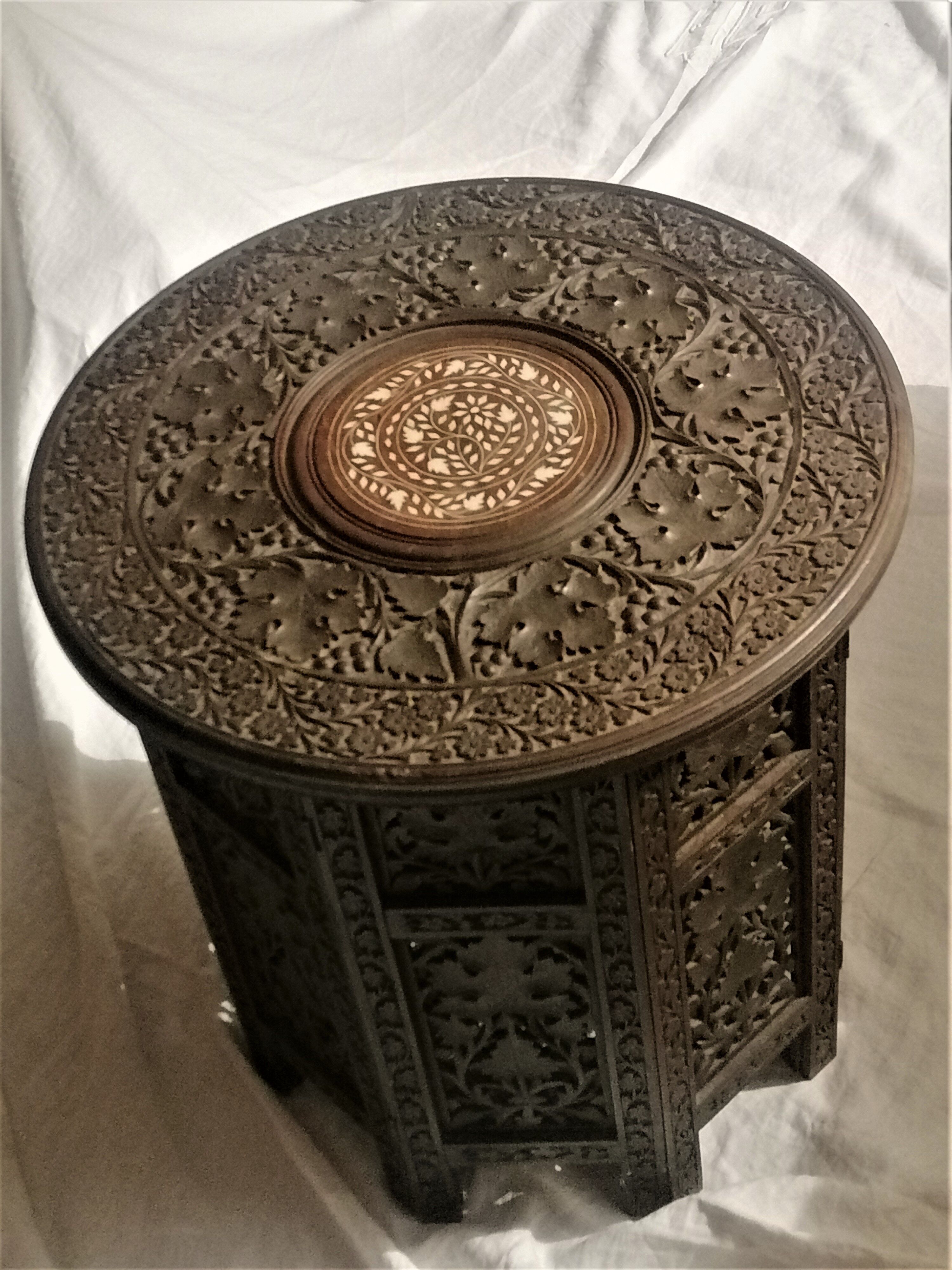 Ancient oriental pedestal table in carved wood