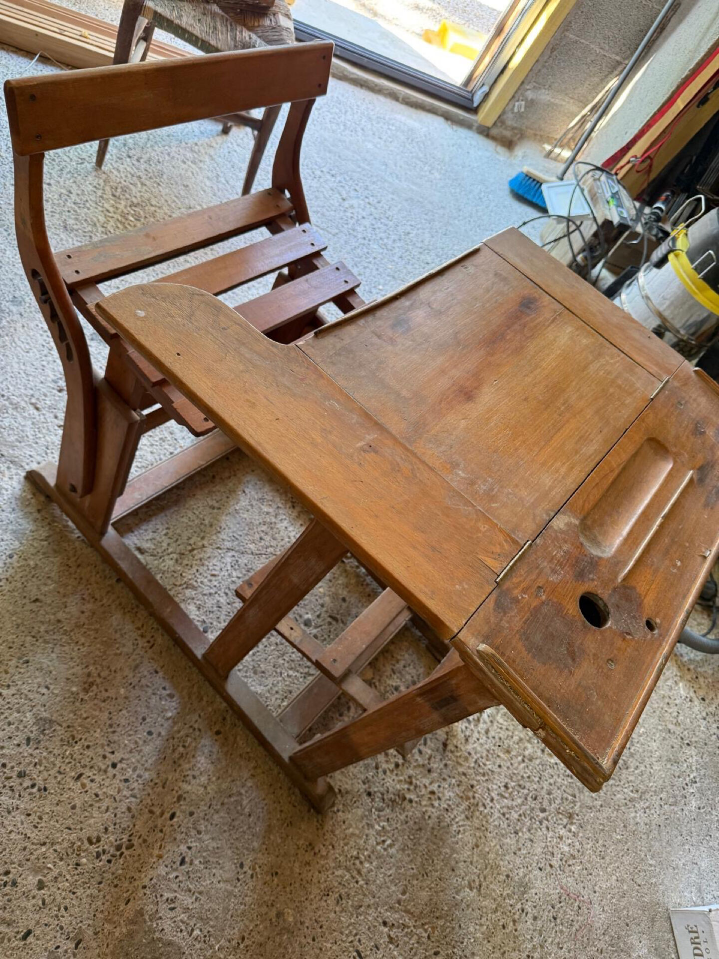 Old school desk with integrated adjustable seat.