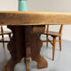 Round table in solid wood, thick top, vintage brutalist style from the 1960s.