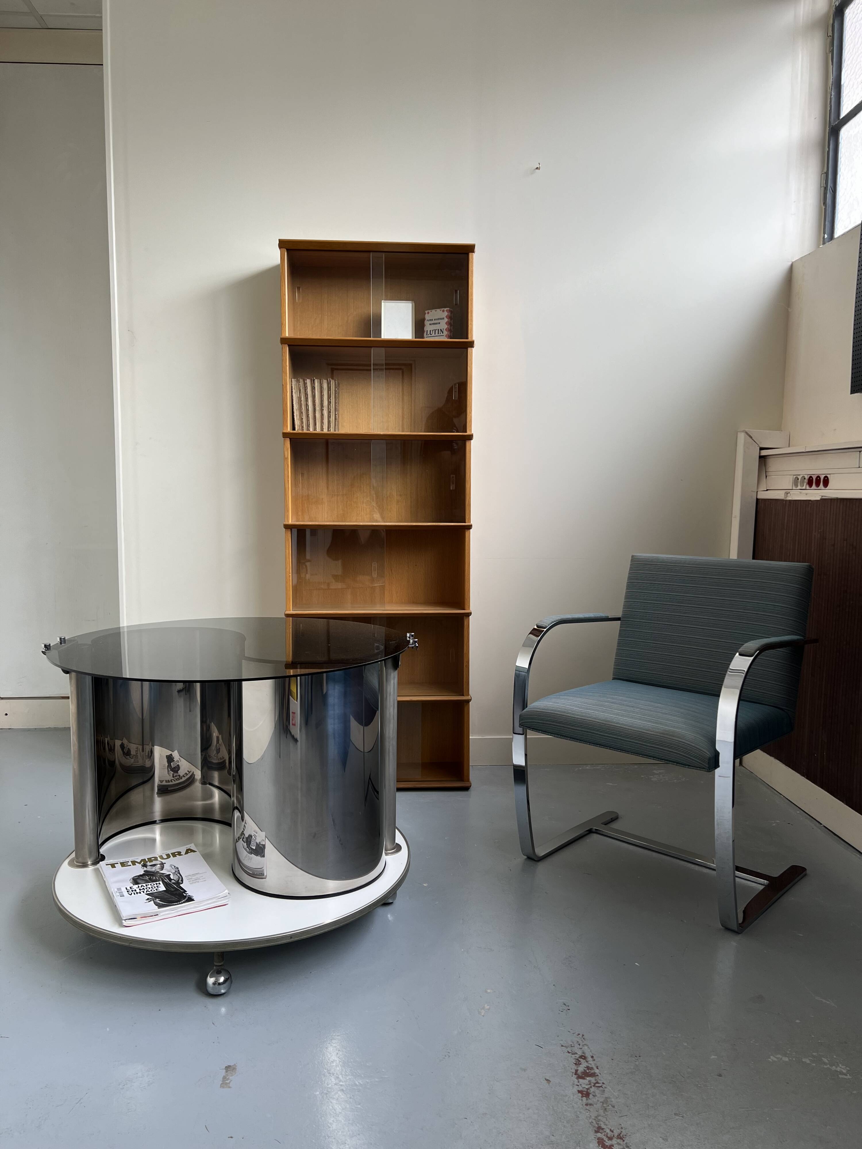 Vintage metal and smoked glass coffee table on casters bar