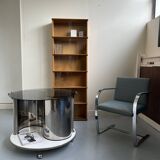 Vintage metal and smoked glass coffee table on casters bar