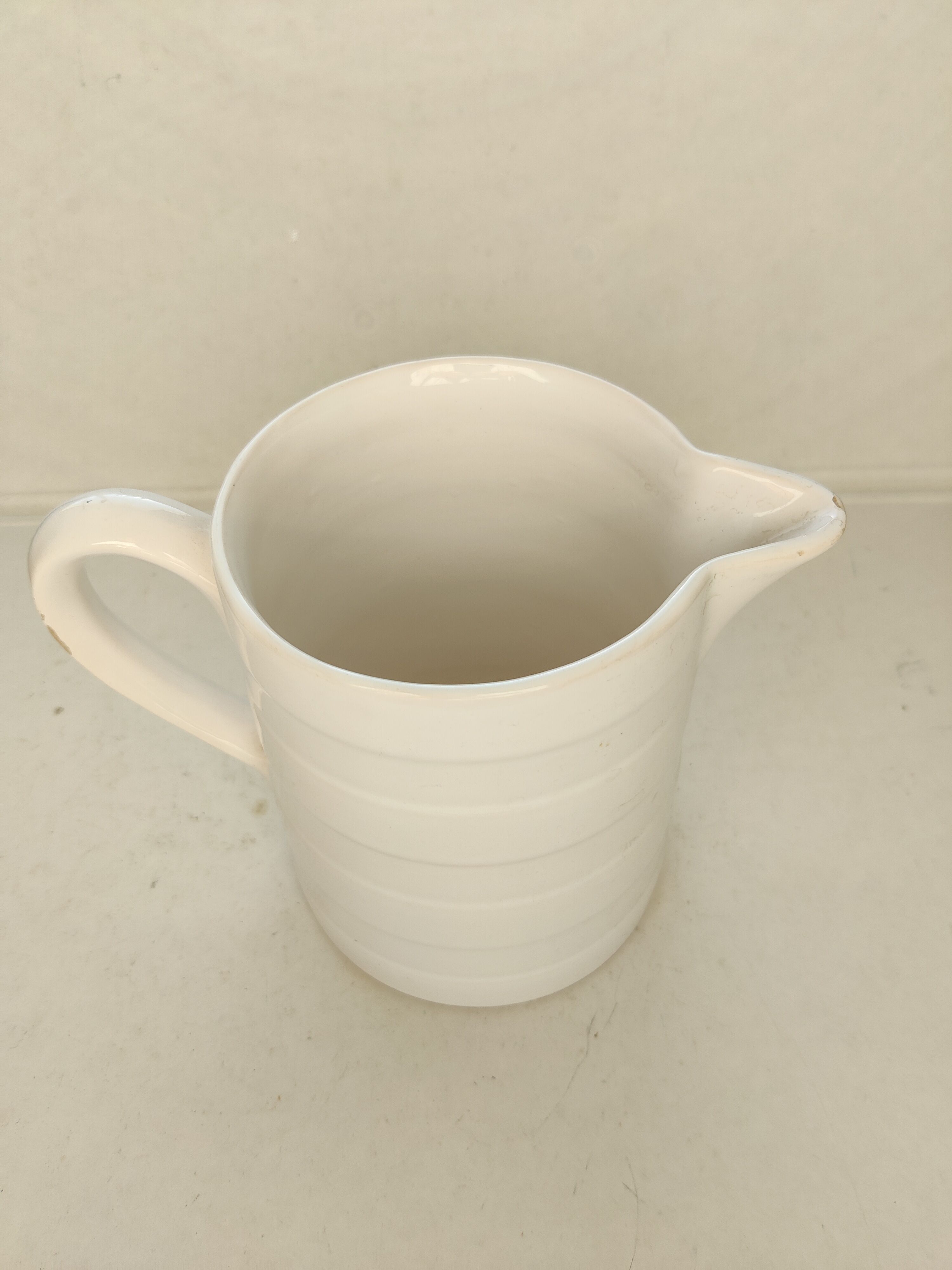 Antique white ceramic pitcher