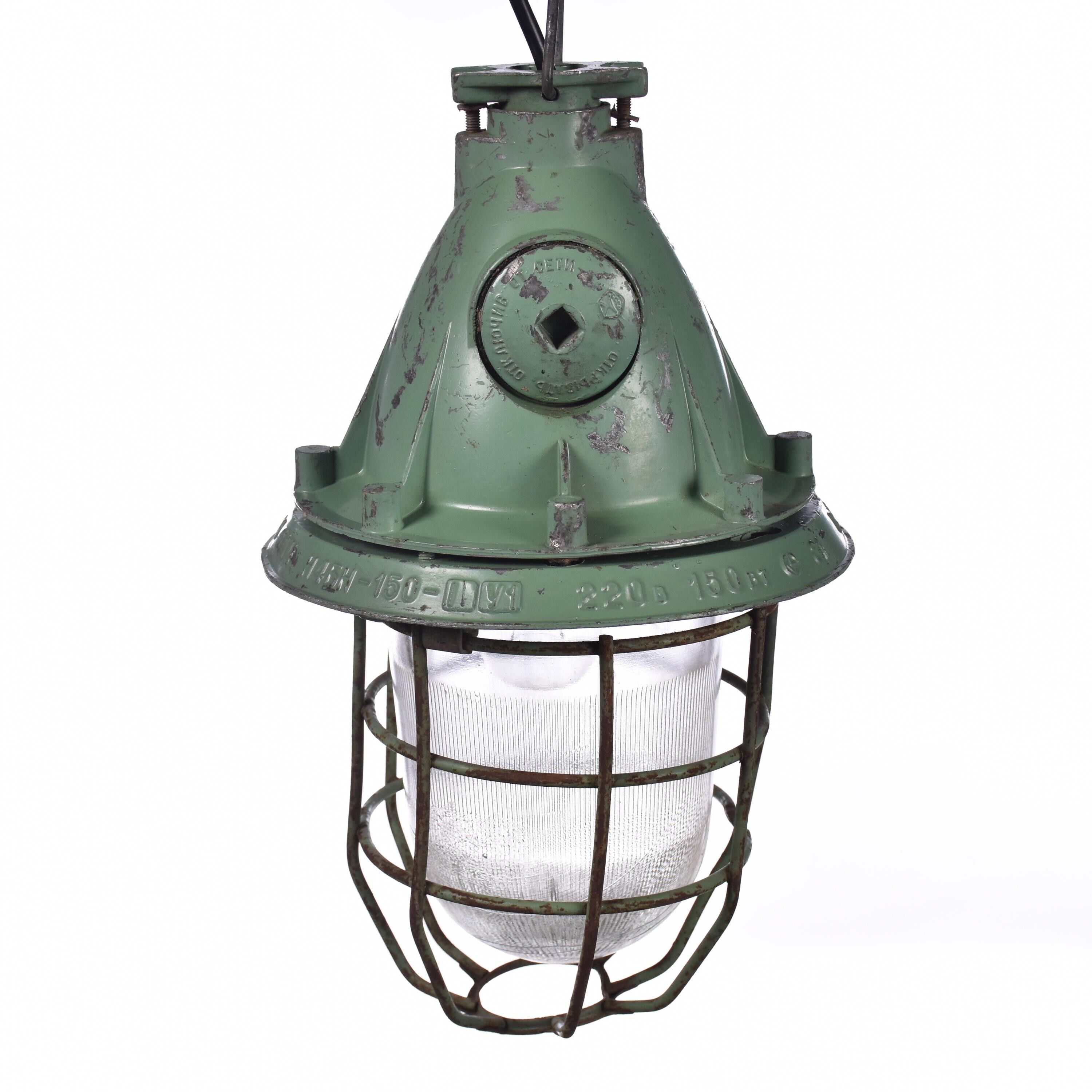 Industrial caged green lamp