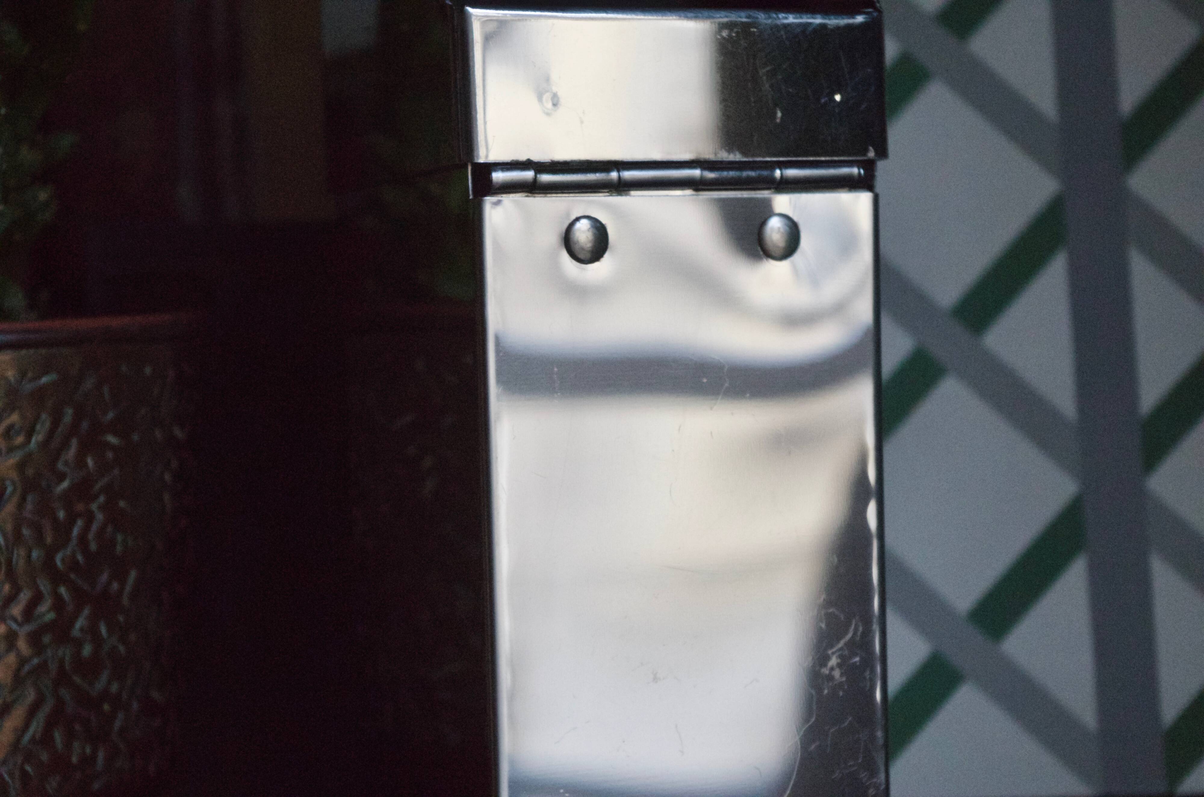Vintage wall ashtray in shiny metal industrial style