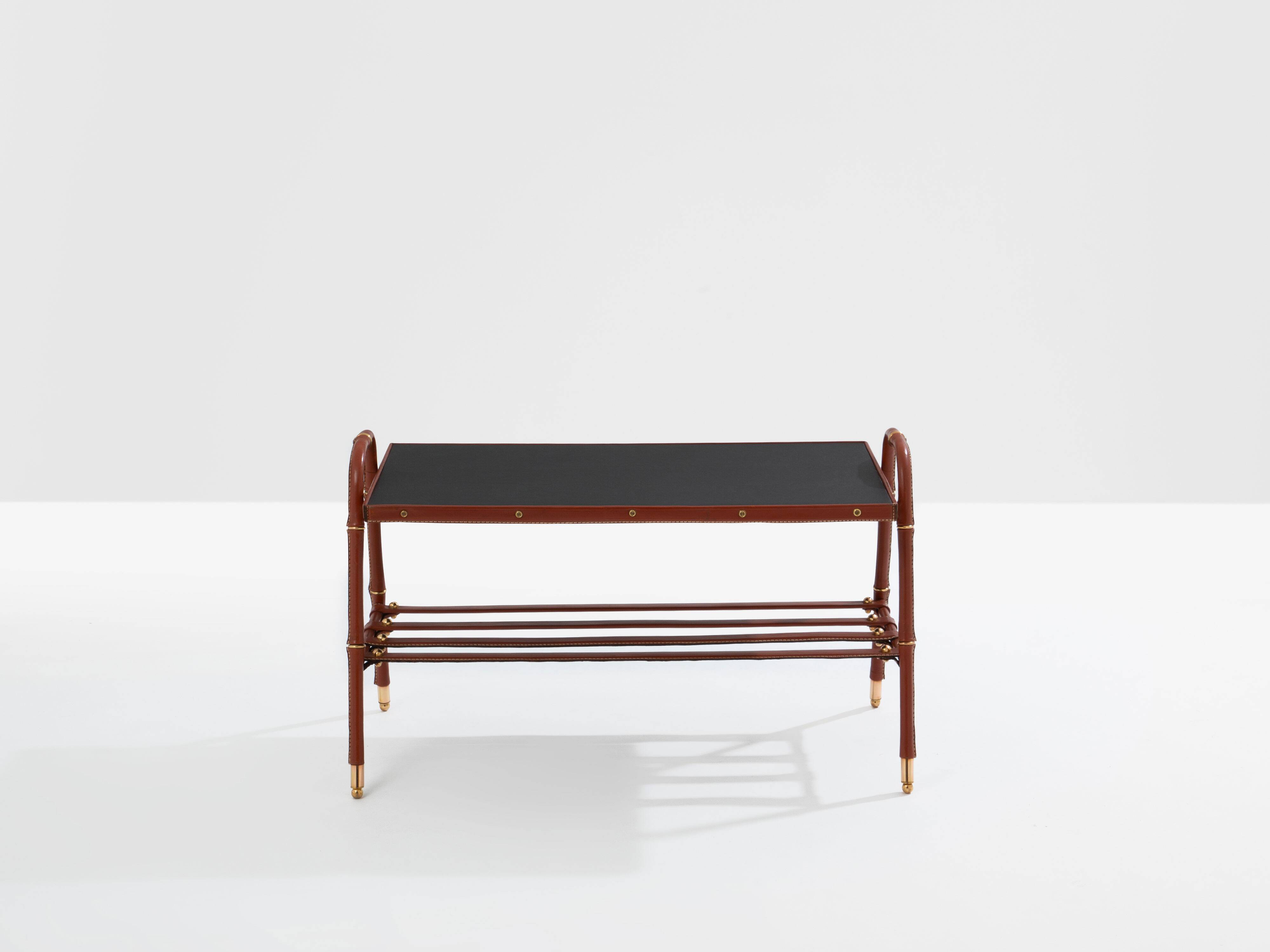 Jacques Adnet coffee table in red saddle-stitched leather and brass, 1950s