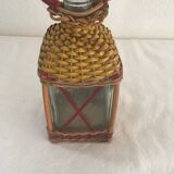 Bottle sheathed on the top and the low d wicker woven