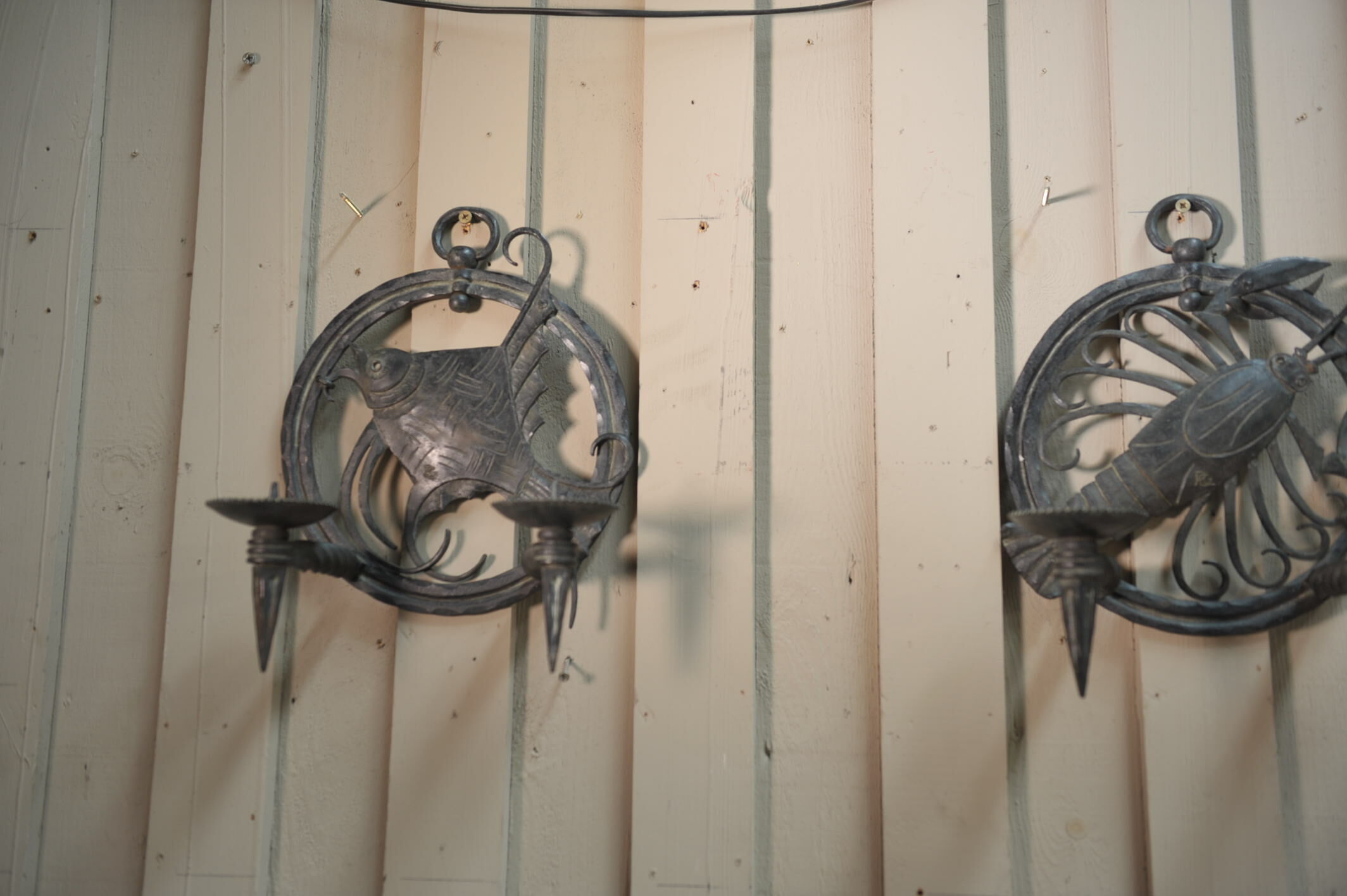 Pair of carved metal wall lamps signed RG