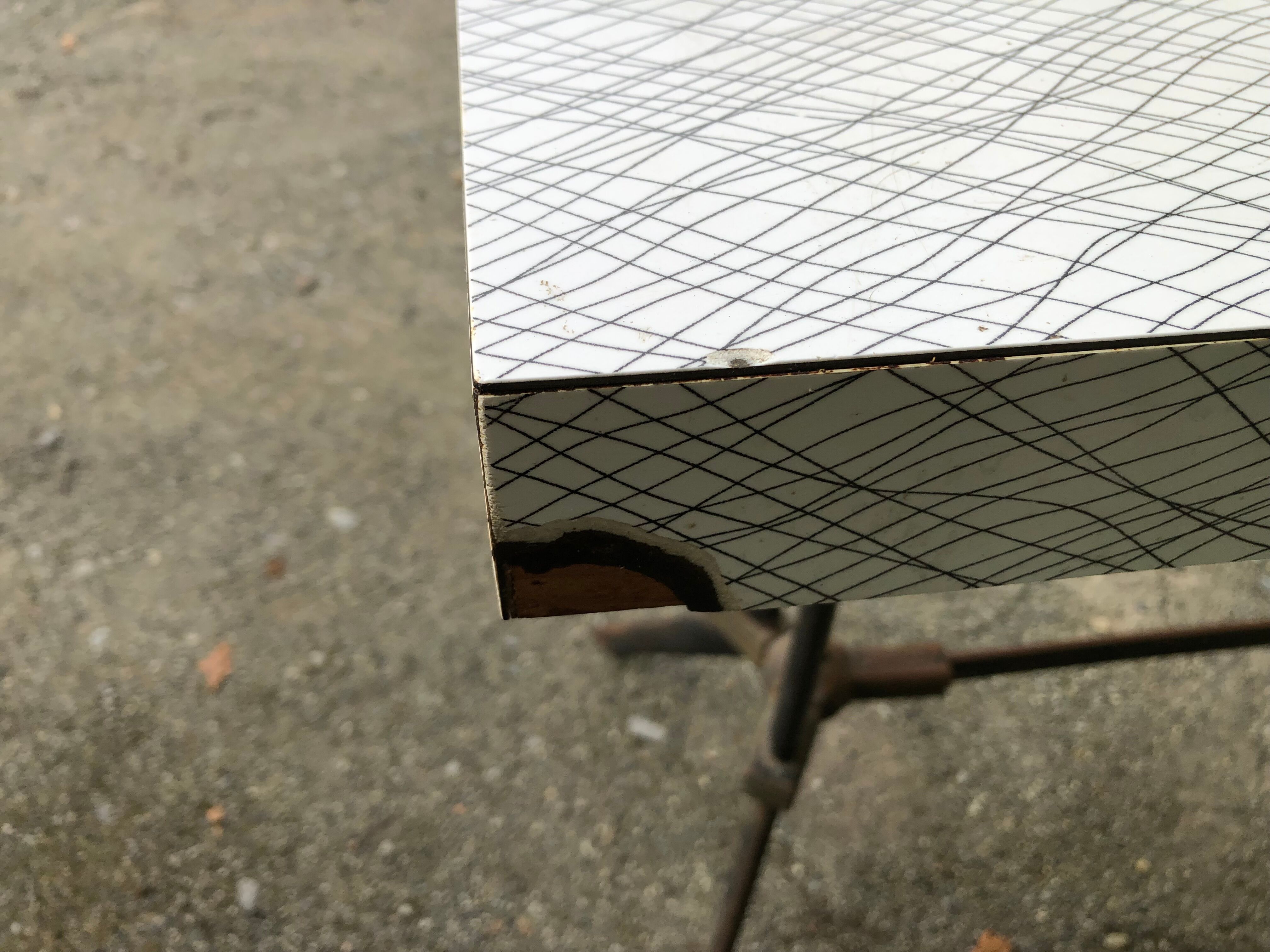 Vintage bistro table with an Art Deco style cast iron base and Formica top.