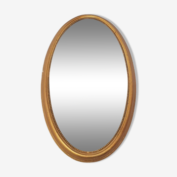 Golden oval mirror