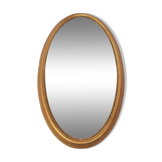 Golden oval mirror