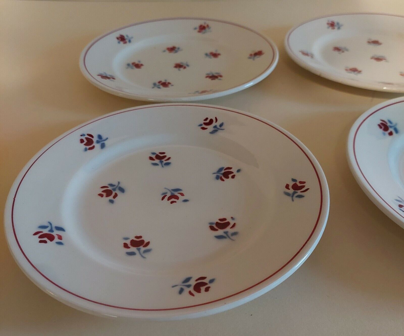 Series of four dessert plates in earthenware Saint Amand décor Rosettes