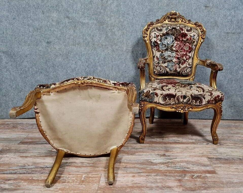 Pair of carved and gilded cabriolet armchairs in the Louis XV style.