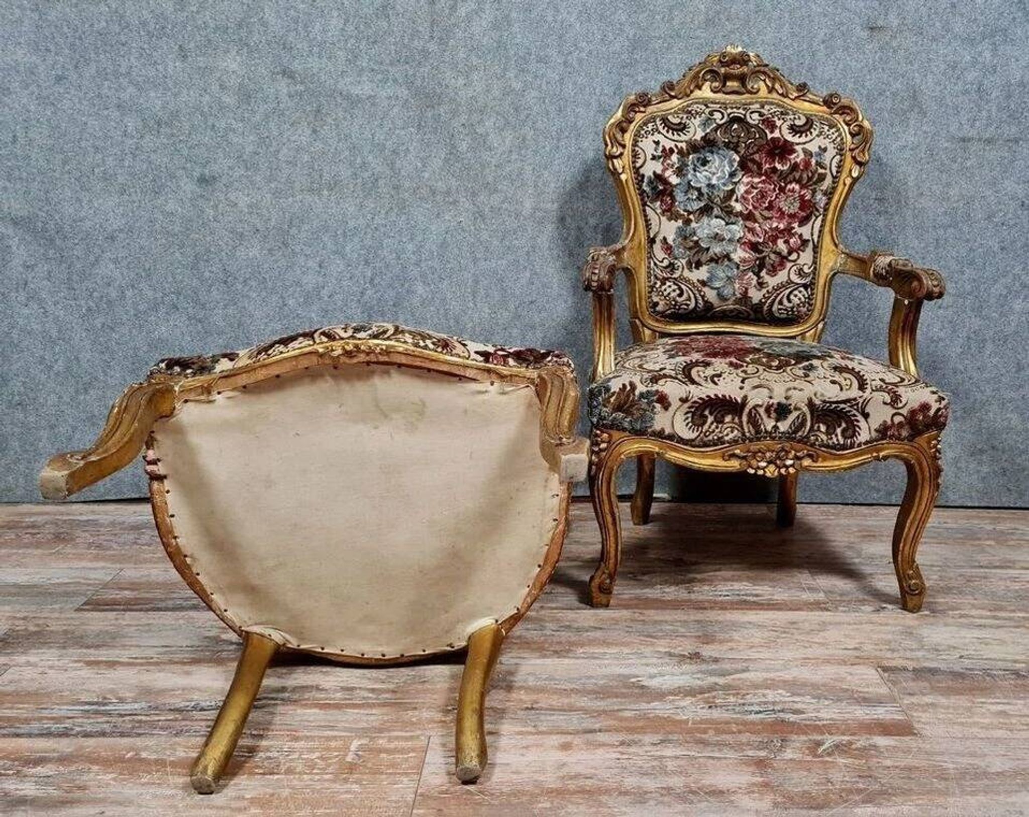 Pair of carved and gilded cabriolet armchairs in the Louis XV style.