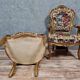 Pair of carved and gilded cabriolet armchairs in the Louis XV style.
