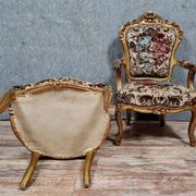 Pair of carved and gilded cabriolet armchairs in the Louis XV style.