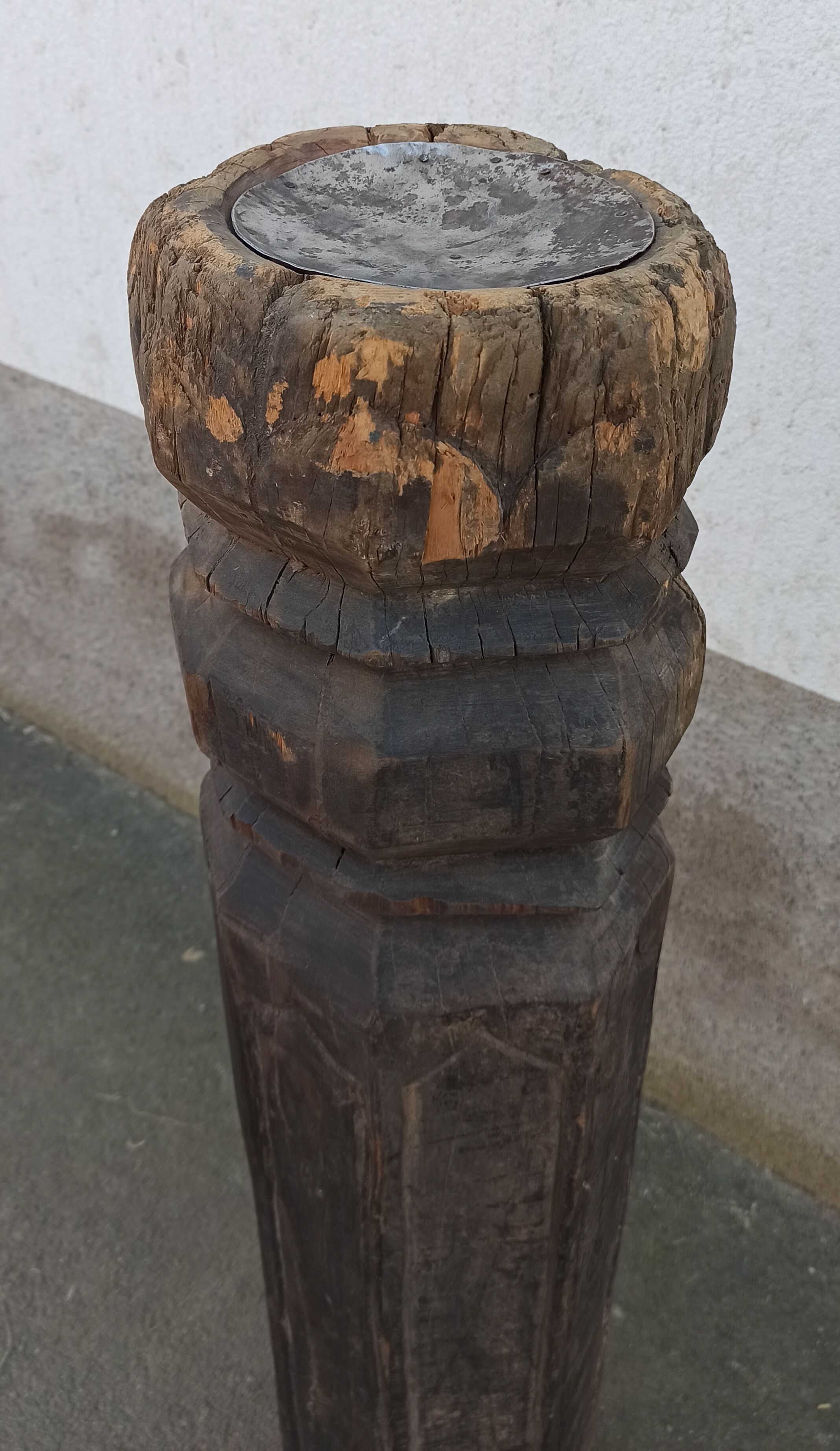 Old wooden pillar on pedestal