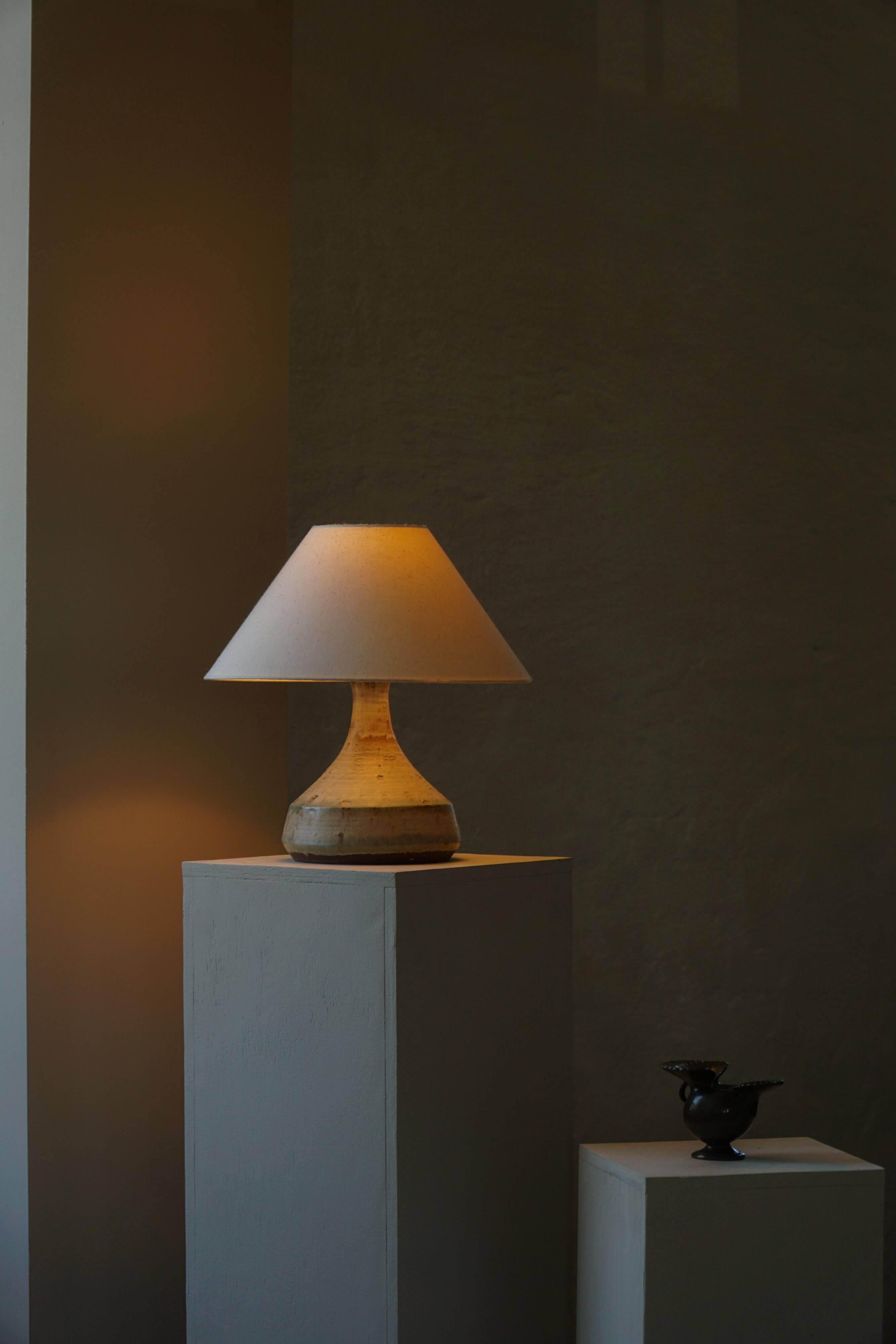Modern Danish decorative table lamp in stoneware with flared base, Denmark, 1960s.
