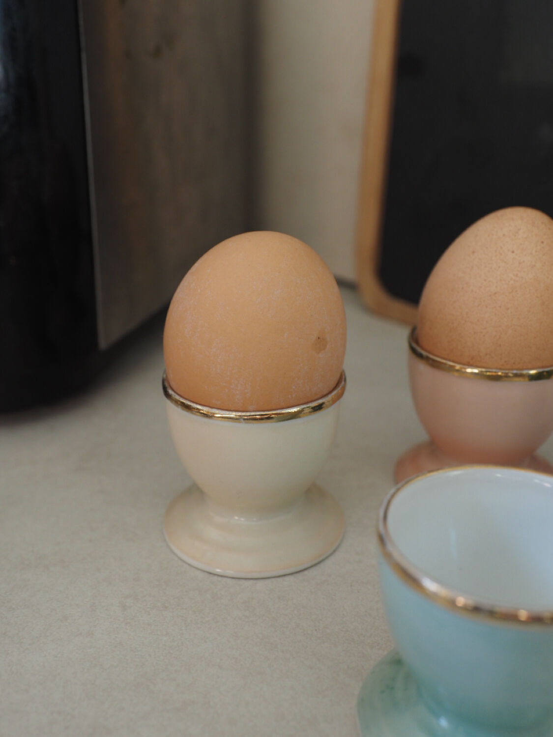 Four coloured egg cups with a golden rim from the 50s.