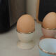 Four coloured egg cups with a golden rim from the 50s.