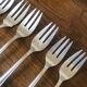 8 mismatched fish forks, silver metal