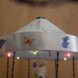 Old toy made of wood, aluminum and fabrics, animated and musical merry-go-round