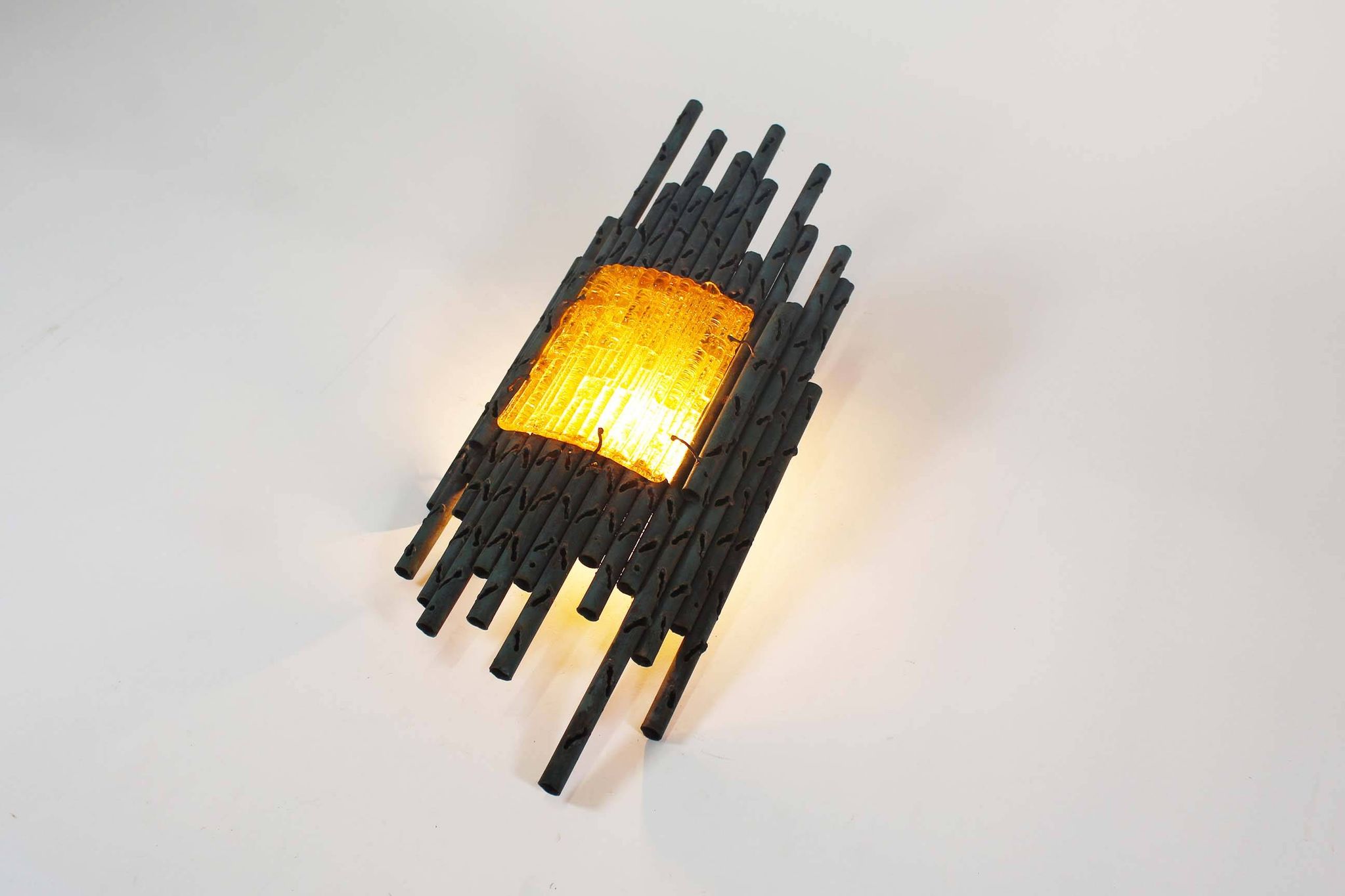 brutalist rough iron and glass wall sconce by Marcello Fantoni
