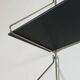 Mid-century vintage shelf in a loop shape, black glass and metal.