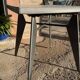 Pedestal table with airplane wing legs