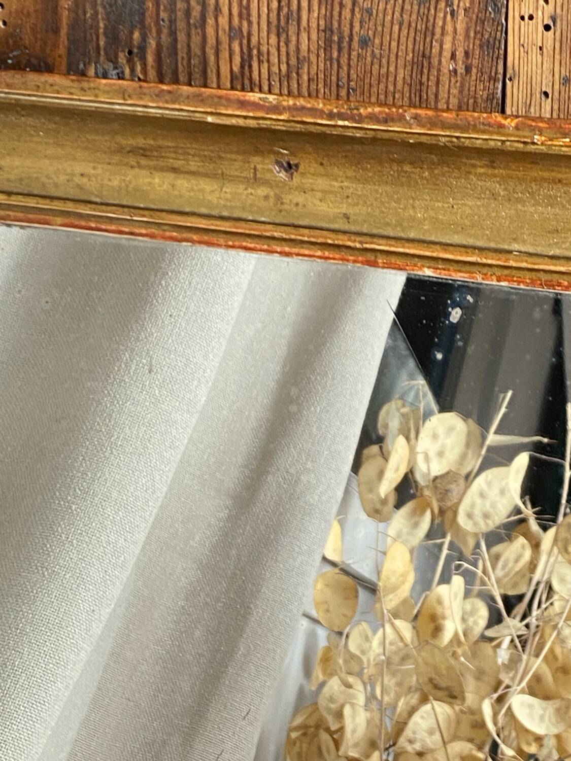 Antique mirror in gilded wood