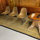 Tandem bench with brown Naugahyde pad shell chairs by Charles and Ray Eames for Herman Miller