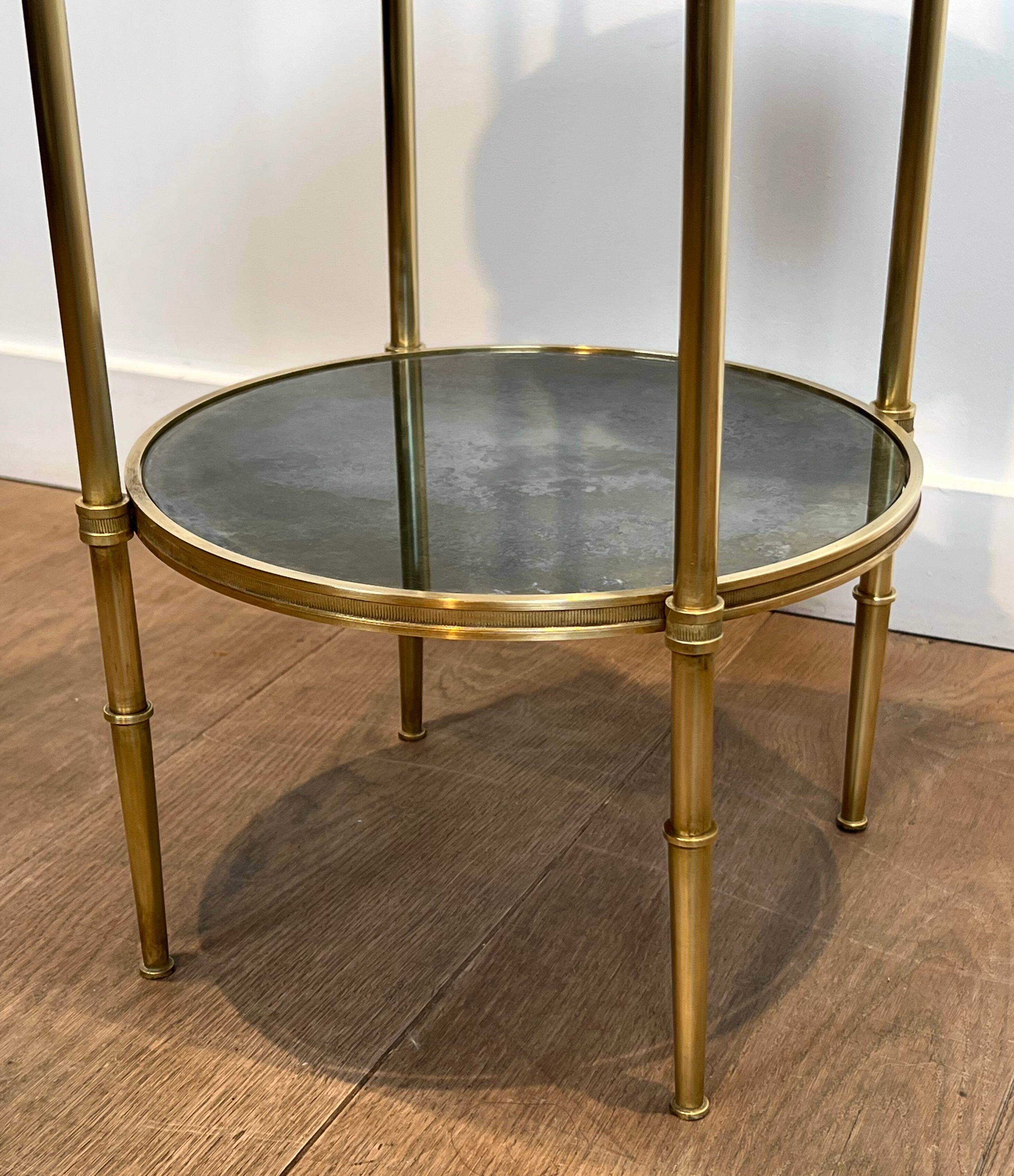 Round bronze side table with triple shelves of églomisé mirrors from Maison Baguès