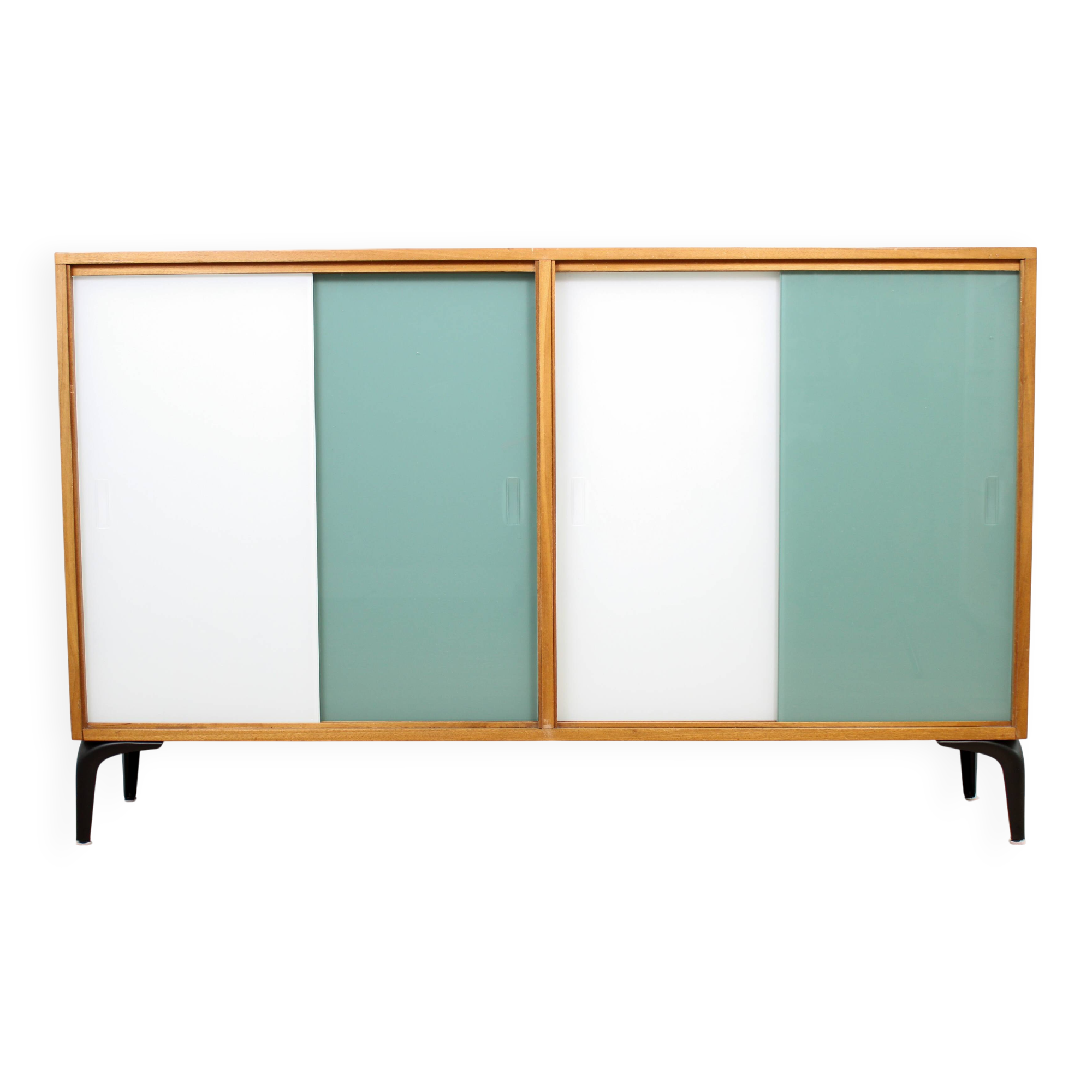 A vintage mid-century bookshelf/sideboard with green and white sliding door