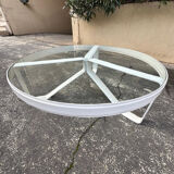 Round coffee table with a metal/leather frame and glass top by Roche Bobois.