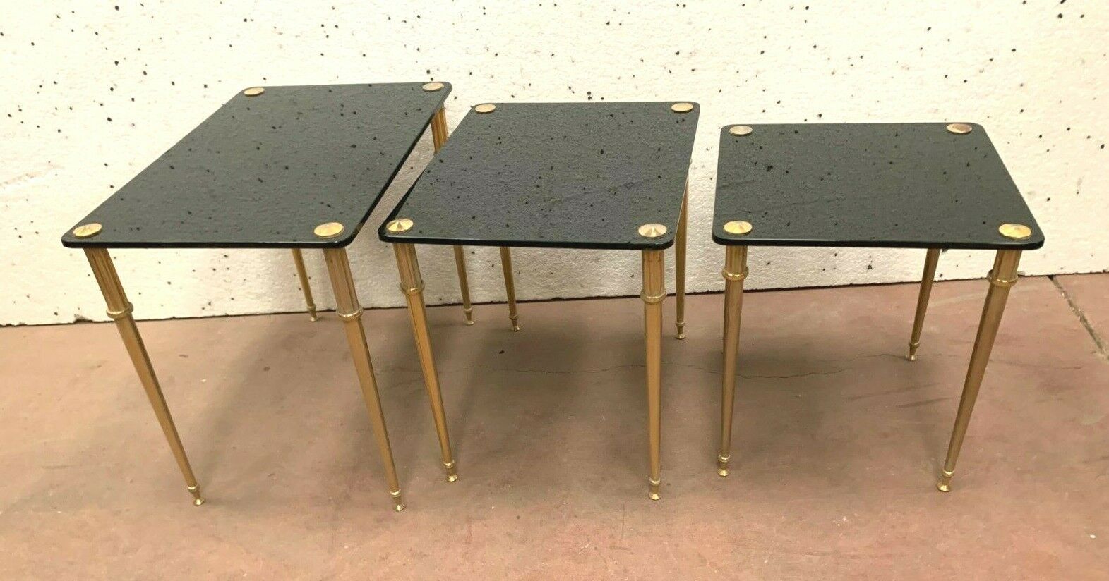 Pull out tables in brass and black glass XX century