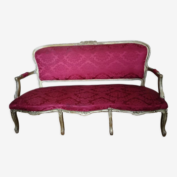 Louis XV style sofa in gilded wood and red pompadour fabric