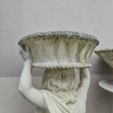 Antique reconstituted stone planter depicting a cherub