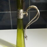 Large decanter with large glass neck and silver metal handle.