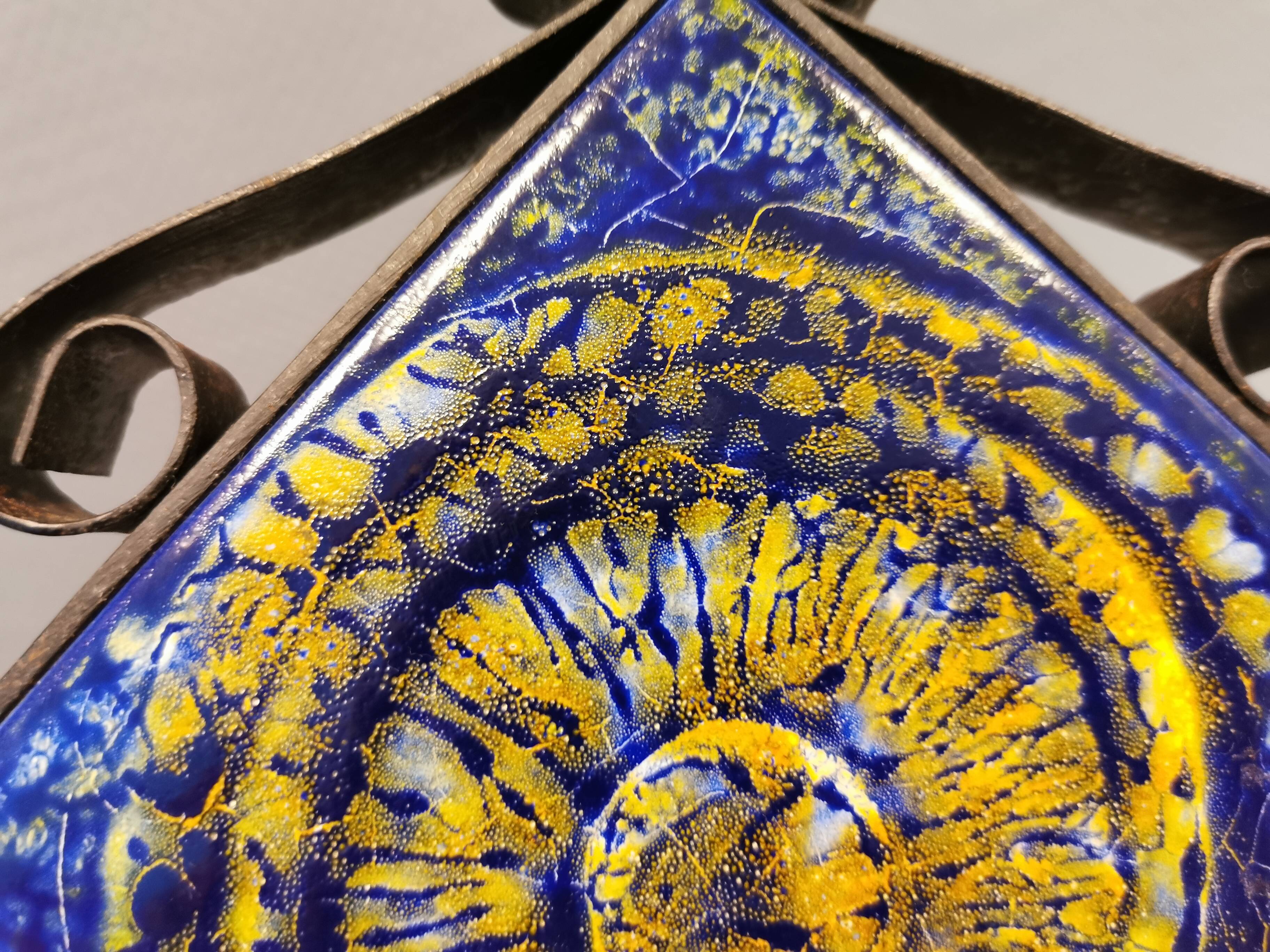 Wall-mounted candle holder in cast iron and ceramic. Estimated Danish and from the 70s.