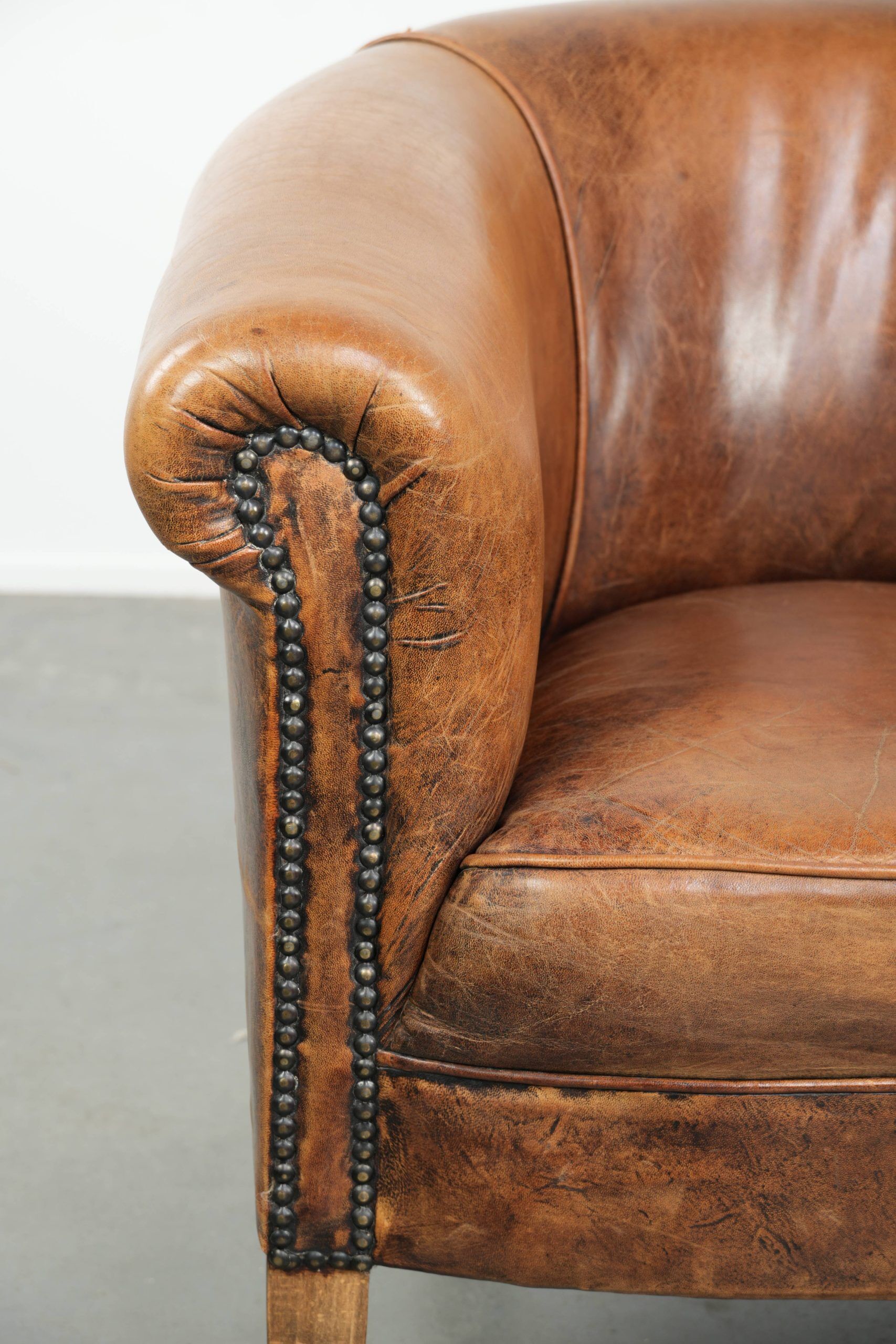 Vintage sheepskin club armchair in a subtle size with warm colours