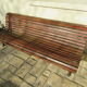 Public bench in wooden slats and cast iron legs