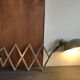 Old extendable accordion lamp in celadon green, workshop spirit.