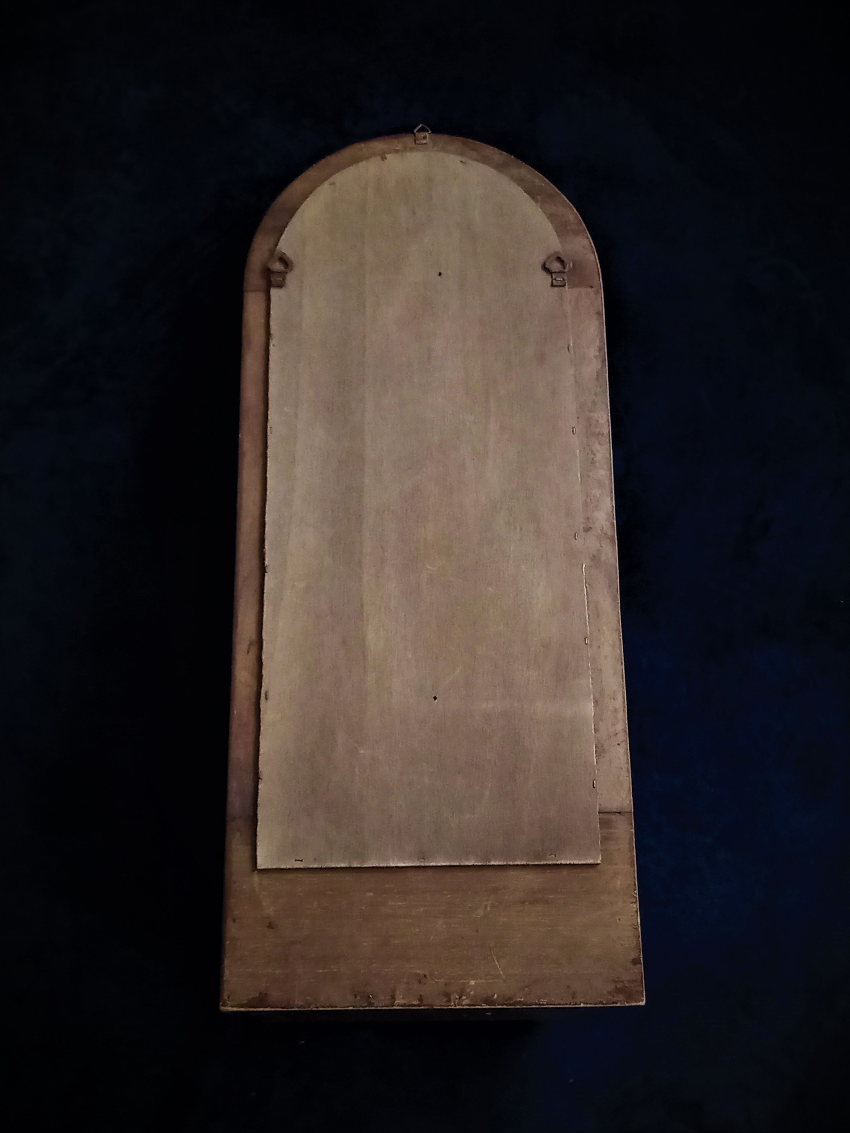 Wall mirror in arched frame with drawer