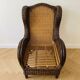 Vintage armchair in rattan and wicker with beige cushion.