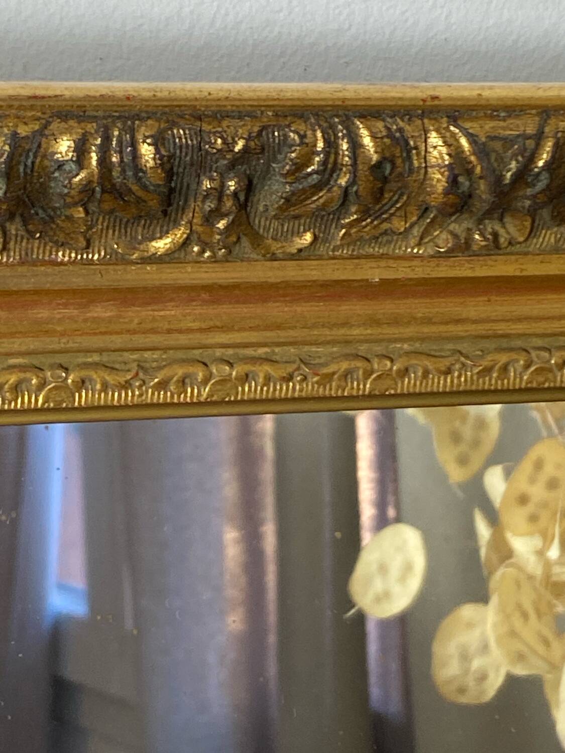 Antique mirror in carved gilded wood