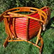Fauteuil vintage rouge en rotin et skai rouge