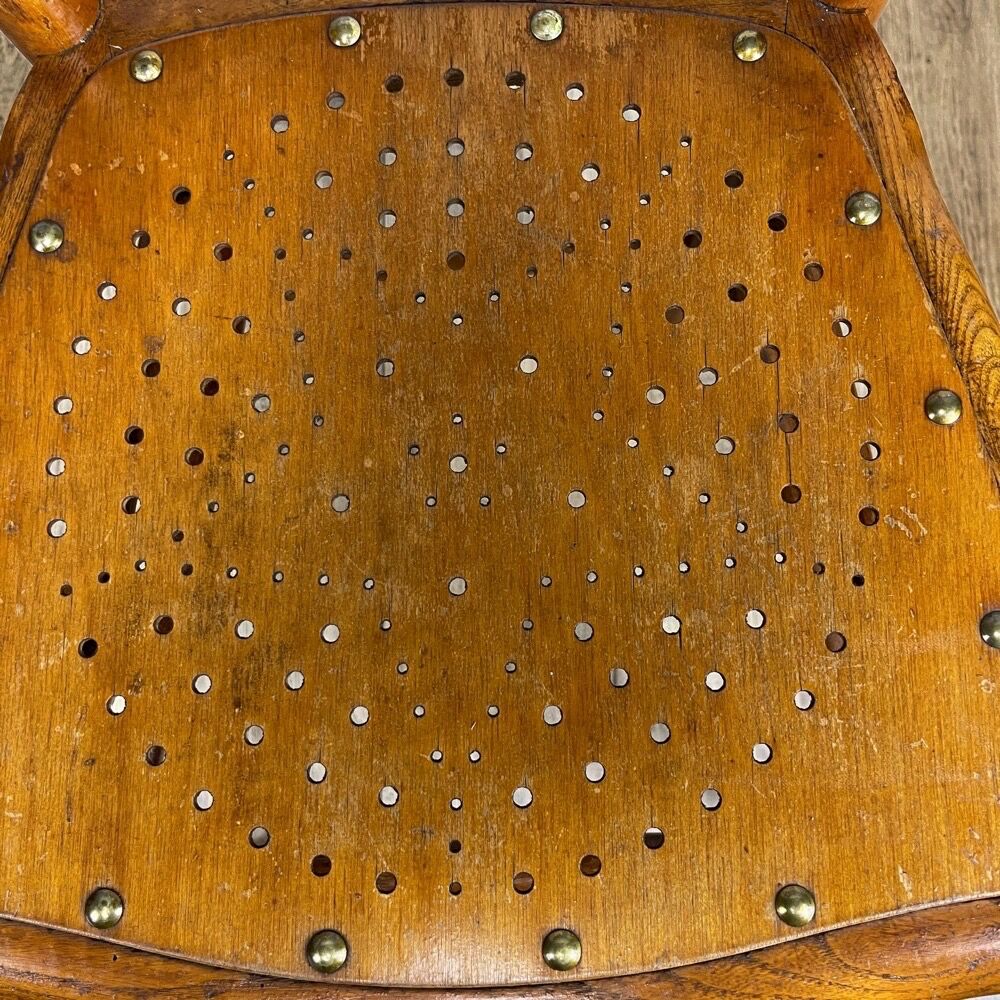 Pair of curved wood bistro chairs and studded and perforated seat